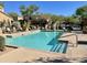 Community pool with steps for easy access, surrounded by mature trees and lounge chairs at 16600 N Thompson Peak Pkwy # 2050, Scottsdale, AZ 85260
