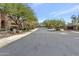 Scenic community street featuring well-maintained roads and lush landscaping under a clear sky at 16600 N Thompson Peak Pkwy # 2050, Scottsdale, AZ 85260