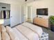 Serene bedroom with closet, soft bedding, dresser and TV for comfortable modern living at 16753 N 157Th Ave, Surprise, AZ 85374