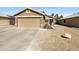Charming single-story home with a two-car garage and low maintenance desert landscaping in the front yard at 16753 N 157Th Ave, Surprise, AZ 85374