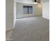 Open living room with neutral carpeting, ceiling fan and a window with a view at 16753 N 157Th Ave, Surprise, AZ 85374