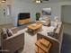 Stylishly furnished living room with neutral tones, plush seating, and a cozy rug creating a welcoming space at 16753 N 157Th Ave, Surprise, AZ 85374