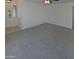 Spacious, light-filled room featuring neutral carpet, ceiling fan and entrance showcasing the home's bright interior at 16753 N 157Th Ave, Surprise, AZ 85374