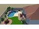 Aerial view of a backyard with a pool, patio, lush lawn, and palm trees at 18033 W Tecoma Rd, Goodyear, AZ 85338
