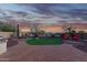 Expansive backyard features a landscaped patio, seating area, and view fencing that borders desert landscaping at 18033 W Tecoma Rd, Goodyear, AZ 85338