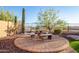 An inviting backyard oasis featuring a paved patio and an outdoor dining area surrounded by desert landscaping at 18033 W Tecoma Rd, Goodyear, AZ 85338
