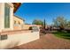 An outdoor kitchen features a built-in grill and a brick-paved patio with an outdoor dining area at 18033 W Tecoma Rd, Goodyear, AZ 85338