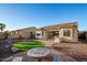 An inviting backyard oasis featuring a paved patio and an outdoor dining area surrounded by desert landscaping at 18033 W Tecoma Rd, Goodyear, AZ 85338