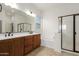 Bathroom featuring dual sinks, vanity, a separate shower, and a soaking tub at 18033 W Tecoma Rd, Goodyear, AZ 85338