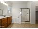 Bathroom featuring dual sinks, vanity, a separate shower, and a soaking tub at 18033 W Tecoma Rd, Goodyear, AZ 85338