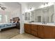Bathroom featuring dual sinks and ensuite main bedroom access at 18033 W Tecoma Rd, Goodyear, AZ 85338