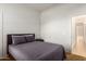 The bedroom is carpeted and has a comfortable bed and nightstand at 18033 W Tecoma Rd, Goodyear, AZ 85338