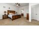 Comfortable bedroom featuring carpeted floors, ceiling fan and ensuite bath access at 18033 W Tecoma Rd, Goodyear, AZ 85338