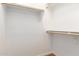 A walk-in closet featuring wooden rails for ample storage at 18033 W Tecoma Rd, Goodyear, AZ 85338