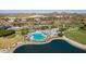 Aerial view of the community pool and recreation area with multiple pools, palm trees, and water features at 18033 W Tecoma Rd, Goodyear, AZ 85338