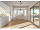 Bright dining room with tile flooring, contemporary chandelier, and slider to the outdoor space at 18033 W Tecoma Rd, Goodyear, AZ 85338