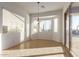 Sunlit dining area with tile flooring, modern light fixture, and sliding doors to the patio at 18033 W Tecoma Rd, Goodyear, AZ 85338