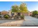 Single story house with desert landscaping, beige facade, and a neutral colored garage door at 18033 W Tecoma Rd, Goodyear, AZ 85338