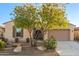 Charming single-story home boasts a well-maintained lawn, desert landscaping, and a two-car garage at 18033 W Tecoma Rd, Goodyear, AZ 85338