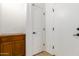 A hallway with storage cabinets and white doors and trim at 18033 W Tecoma Rd, Goodyear, AZ 85338