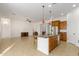 Open kitchen with granite island, stainless appliances, and seamless flow into the living area at 18033 W Tecoma Rd, Goodyear, AZ 85338