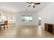 Spacious living room with tile flooring, ceiling fan, and large windows providing natural light at 18033 W Tecoma Rd, Goodyear, AZ 85338