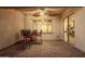 Covered patio area with ceiling fan, paver flooring, table and chairs, and sliding glass door access at 18033 W Tecoma Rd, Goodyear, AZ 85338