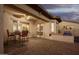 Covered patio featuring a dining set and built-in grill, connecting seamlessly to the kitchen at 18033 W Tecoma Rd, Goodyear, AZ 85338