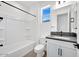 Clean bathroom with a bathtub, toilet, and vanity featuring black hardware and stone countertops at 18123 W Hiddenview Dr, Goodyear, AZ 85338