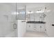 Bright bathroom featuring double sinks, sleek fixtures, and a glass-enclosed shower at 18123 W Hiddenview Dr, Goodyear, AZ 85338