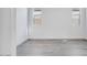 Bright bedroom with two windows and gray wood flooring at 18123 W Hiddenview Dr, Goodyear, AZ 85338