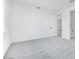 Bright bedroom with neutral carpet, white walls, and a door leading to other parts of the home at 18123 W Hiddenview Dr, Goodyear, AZ 85338