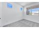 Well-lit bedroom with neutral carpet, white walls, and multiple windows offering natural light at 18123 W Hiddenview Dr, Goodyear, AZ 85338