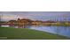 Beautiful community lake with lush green surroundings, perfect for relaxation and recreation at sunset at 18123 W Hiddenview Dr, Goodyear, AZ 85338