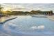 Stunning community pool with inviting water features and comfortable lounging areas for residents to unwind and enjoy the sun at 18123 W Hiddenview Dr, Goodyear, AZ 85338