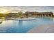 Luxurious community pool with water features and ample seating for residents to enjoy a resort lifestyle at 18123 W Hiddenview Dr, Goodyear, AZ 85338