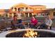Inviting outdoor fire pit area, perfect for relaxing and entertaining friends in a luxurious community at 18123 W Hiddenview Dr, Goodyear, AZ 85338