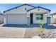 Charming single-story home with a two-car garage and professionally landscaped front yard at 18123 W Hiddenview Dr, Goodyear, AZ 85338