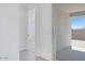 Hallway with tile flooring leading to a patio and another room in the home at 18123 W Hiddenview Dr, Goodyear, AZ 85338