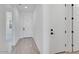 Hallway with tile flooring, multiple doors, and access to various rooms in the home at 18123 W Hiddenview Dr, Goodyear, AZ 85338
