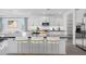 Bright, open kitchen features a large center island with barstool seating and modern appliances at 18123 W Hiddenview Dr, Goodyear, AZ 85338