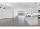 Spacious kitchen and living area with modern lighting and access to the backyard at 18123 W Hiddenview Dr, Goodyear, AZ 85338