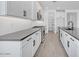 Gorgeous kitchen featuring white cabinets, stainless steel appliances, and wood-look flooring at 18123 W Hiddenview Dr, Goodyear, AZ 85338