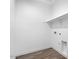 Clean laundry room offering wood-look flooring, ample space, and convenient utility connections at 18123 W Hiddenview Dr, Goodyear, AZ 85338
