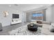 Bright living room with stylish furnishings and sliding glass doors to the backyard at 18123 W Hiddenview Dr, Goodyear, AZ 85338