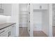Clean pantry with lots of storage located off the kitchen, next to the laundry hookups at 18123 W Hiddenview Dr, Goodyear, AZ 85338