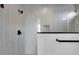 Modern shower with gray tile, a built-in shelf and matte black fixtures, offering a sleek and contemporary feel at 18123 W Hiddenview Dr, Goodyear, AZ 85338