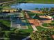 Community aerial view featuring tennis and basketball courts, green spaces, and walking paths at 18150 W Tanglewood Dr, Goodyear, AZ 85338
