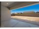 View of an expansive backyard with a concrete patio and potential for landscaping at 18150 W Tanglewood Dr, Goodyear, AZ 85338