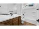 Bathroom featuring wood cabinets, modern fixtures, and a shower/tub combination at 18150 W Tanglewood Dr, Goodyear, AZ 85338